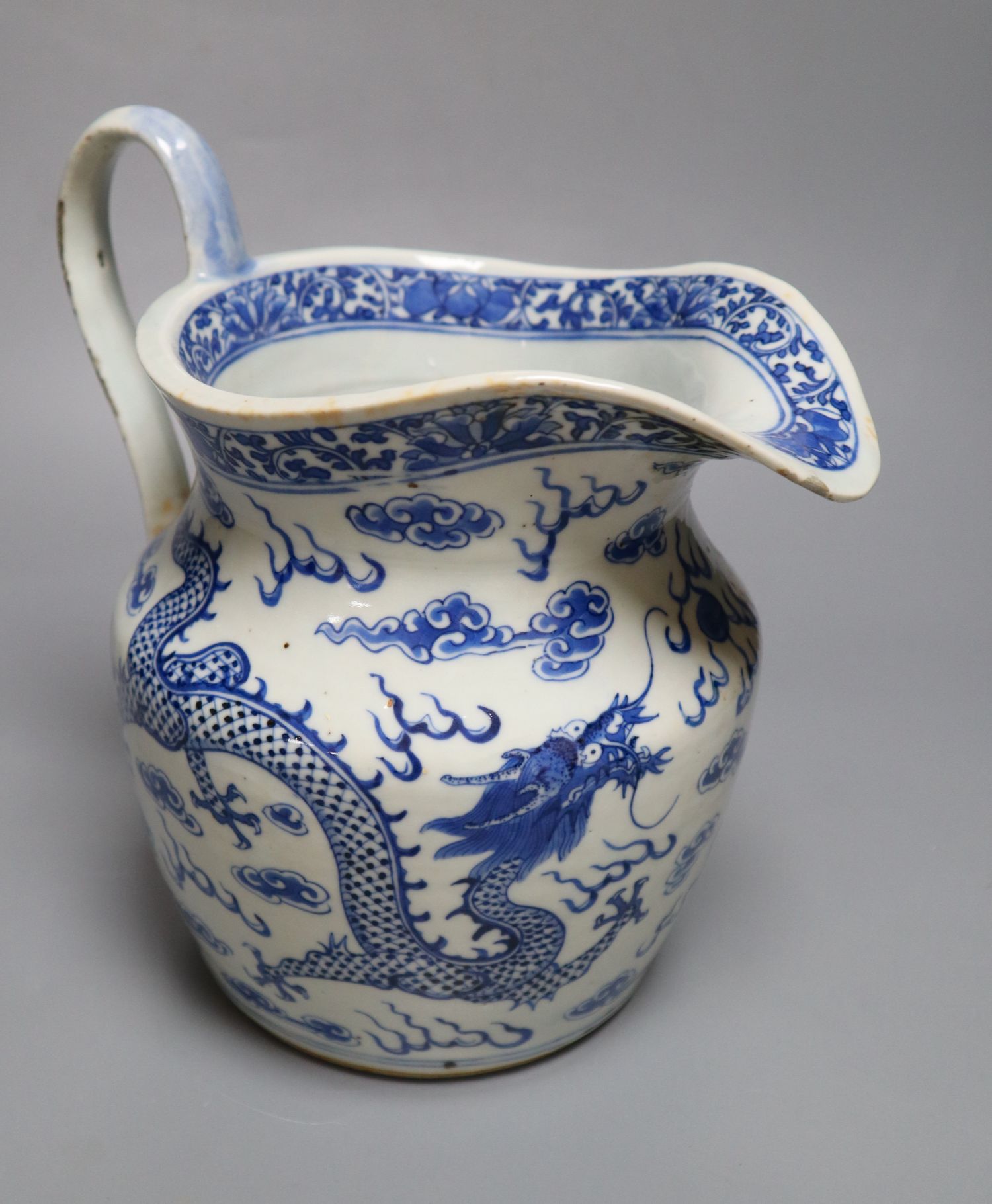 A 19th century Chinese blue and white dragon jug, 22cm